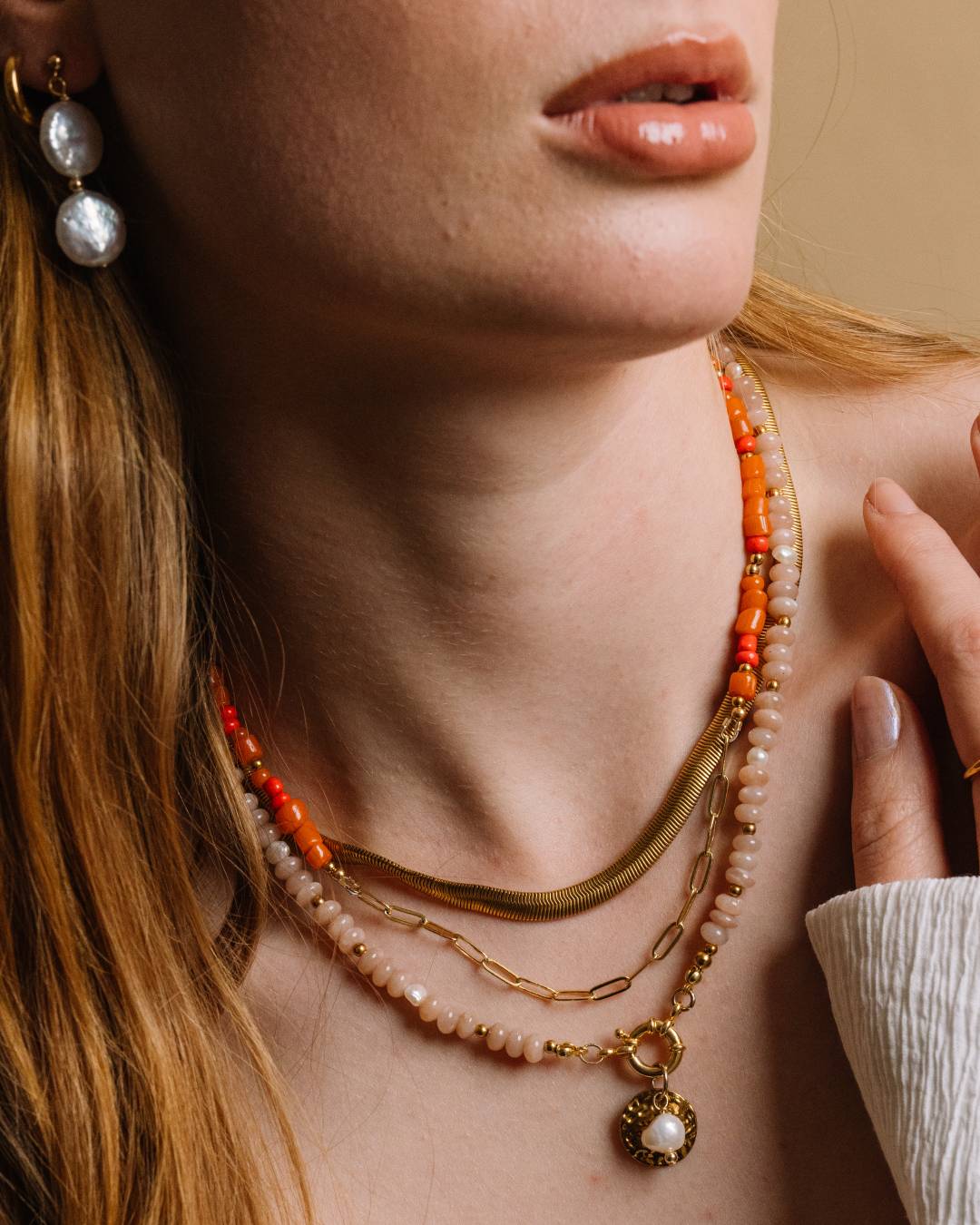Stack of multiple necklaces, including handcrafted moonstone and freshwater pearl gold vermeil beaded necklace, waterproof gold plated herringbone and paperclip chain necklaces
