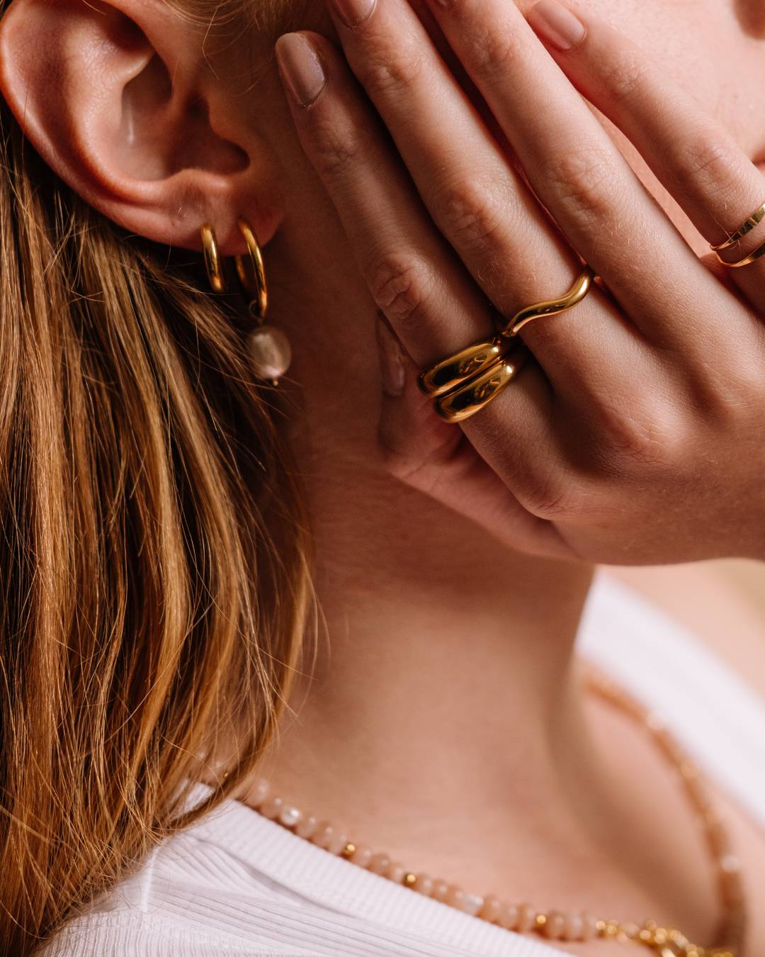 Gold plated waterproof stacking rings with freshwater pearl hoop earring and handcrafted beaded necklace with charms